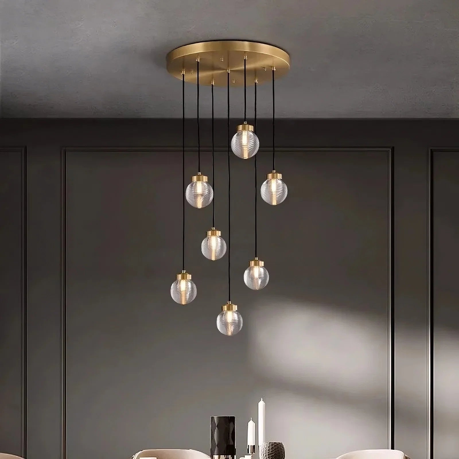 Bossen 7-globe chandelier illuminated over a dining table