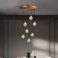 Bossen 7-globe chandelier illuminated over a dining table