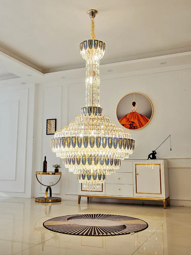 Chandelier casting warm light over polished marble stairs